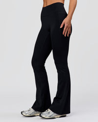 Woman wearing Fusion V-Contour High-Rise Flared Petite Legging Pockets - Black | Model:Issy | Size:XS