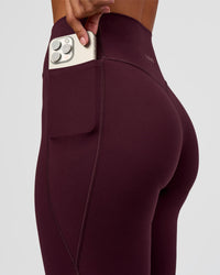 Woman wearing Fusion V-Contour High-Rise Flared Petite Legging Pockets - Cherry Lacquer | Model:Brylee | Size:XS | Thumbnail Index: 3