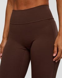Woman wearing Fusion V-Contour High-Rise Flared Petite Legging Pockets - Hot Chocolate | Model:Brylee | Size:XS