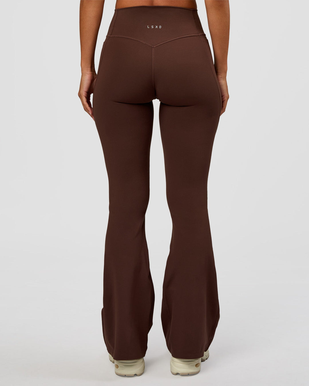 Woman wearing Fusion V-Contour High-Rise Flared Petite Legging Pockets - Hot Chocolate | Model:Brylee | Size:XS
