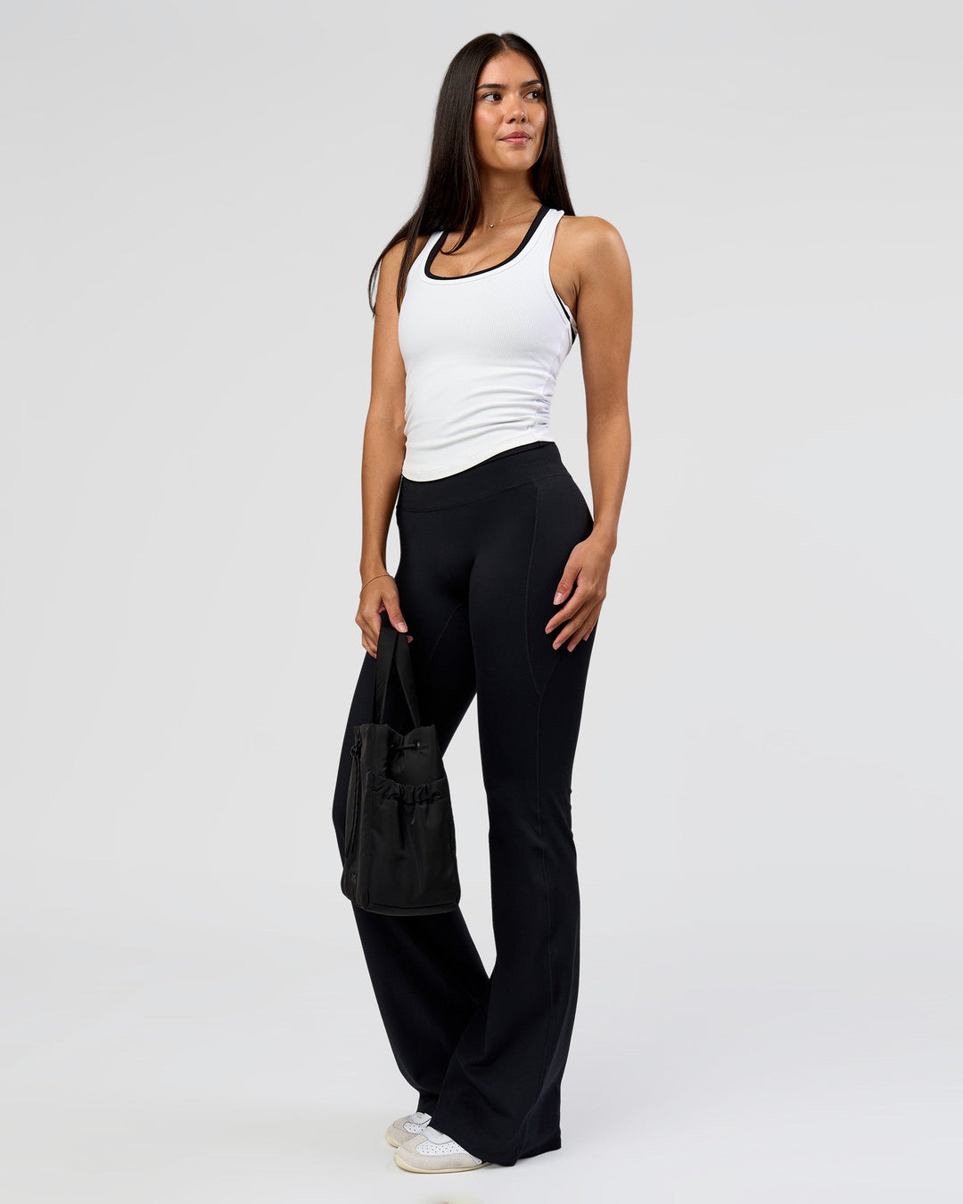 Woman wearing Fusion V-Contour High-Rise Flared Tall Legging Pockets - Black | Model:Rhiley | Size:S