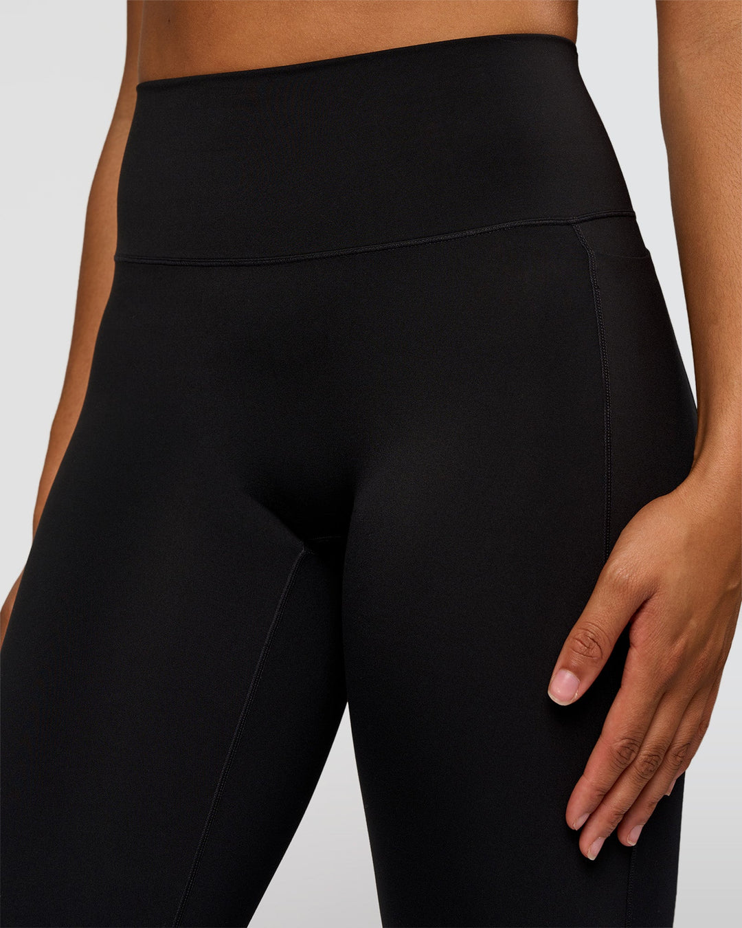 Woman wearing Fusion V-Contour High-Rise Flared Tall Legging Pockets - Black | Model:Rosie | Size:S