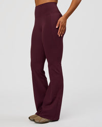 Woman wearing Fusion V-Contour High-Rise Flared Tall Legging Pockets - Cherry Lacquer | Model:Rosie | Size:S | Thumbnail Index: 3