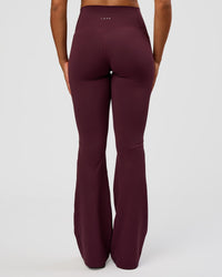 Woman wearing Fusion V-Contour High-Rise Flared Tall Legging Pockets - Cherry Lacquer | Model:Rosie | Size:S | Thumbnail Index: 1