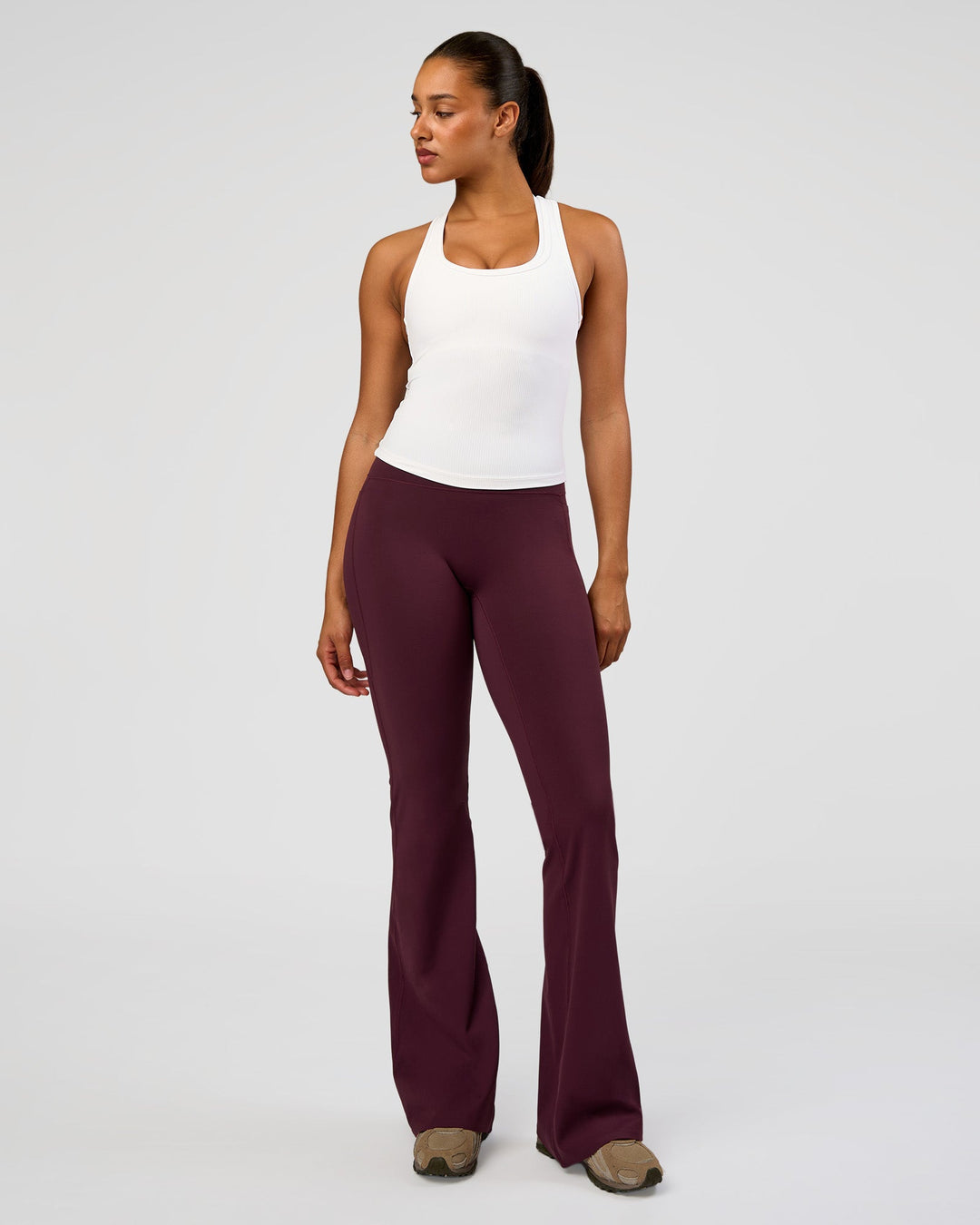 Woman wearing Fusion V-Contour High-Rise Flared Tall Legging Pockets - Cherry Lacquer | Model:Rosie | Size:S