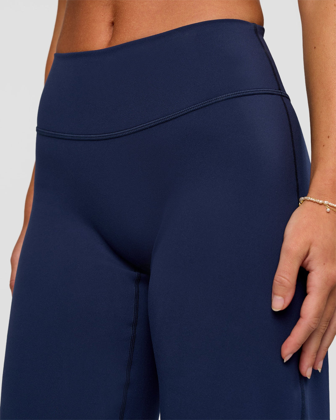 Model wearing Fusion V-Contour High-Rise Petite Pant - Future Navy | Model:Issy | Size:XS