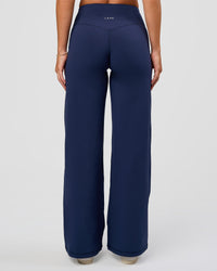 Model wearing Fusion V-Contour High-Rise Petite Pant - Future Navy | Model:Issy | Size:XS