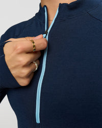 Woman wearing GG AeroFLX+ Long Sleeve Half Zip - Future Navy-Baltic Sea | Model:Grace | Size:XS