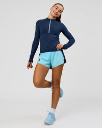 Woman wearing GG AeroFLX+ Long Sleeve Half Zip - Future Navy-Baltic Sea | Model:Grace | Size:XS