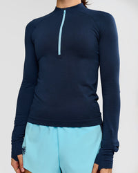 Woman wearing GG AeroFLX+ Long Sleeve Half Zip - Future Navy-Baltic Sea | Model:Grace | Size:XS