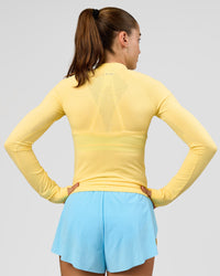 Woman wearing GG AeroFLX+ Long Sleeve Half Zip - Lemon-Baltic Sea | Model:Grace | Size:XS