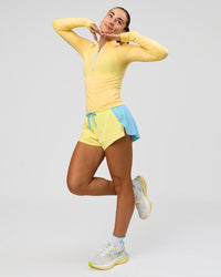 Woman wearing GG AeroFLX+ Long Sleeve Half Zip - Lemon-Baltic Sea | Model:Grace | Size:XS