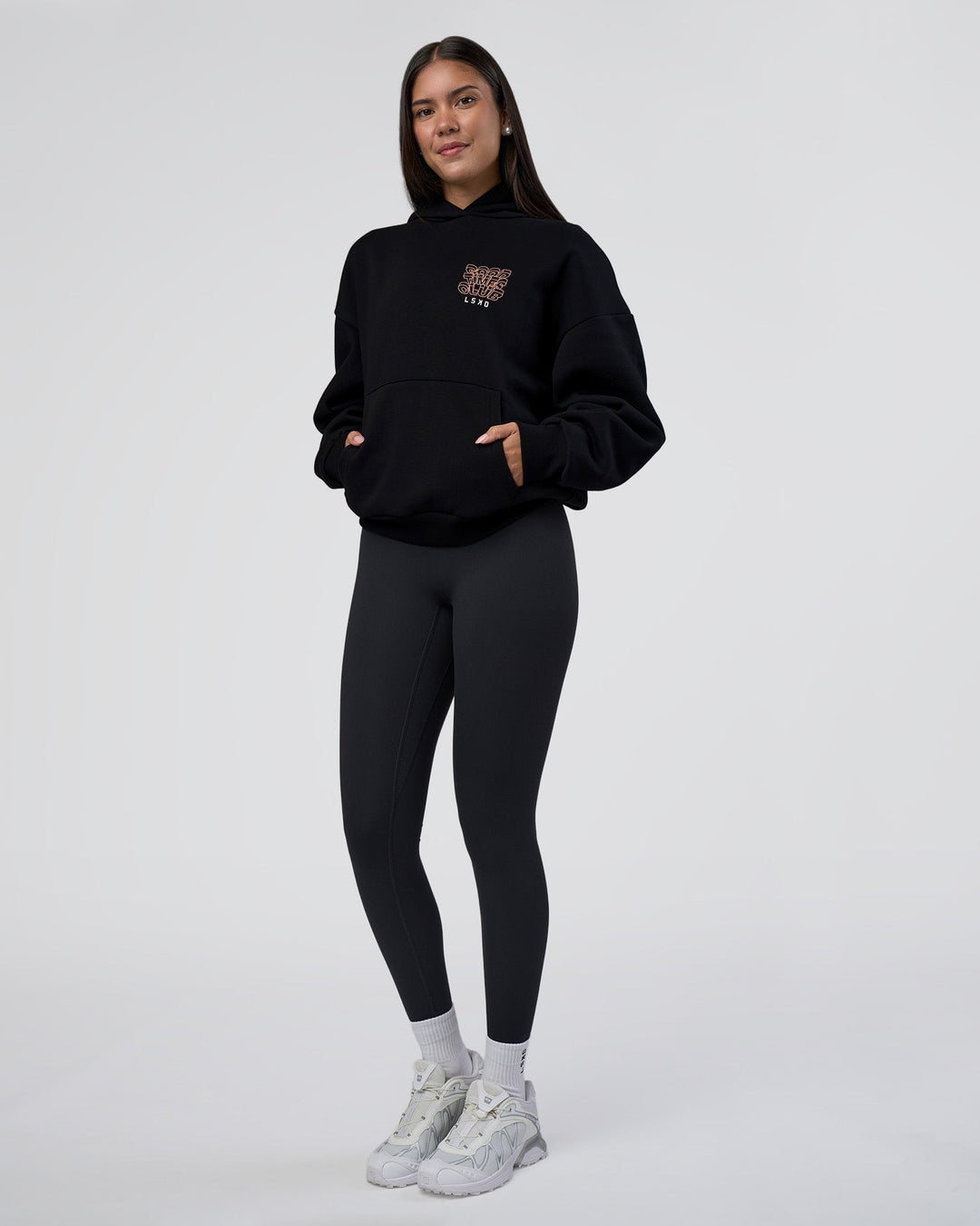 Woman wearing GTC CVC Fleece Unisex Oversized Hoodie - Black-Cantaloupe | Model:Rhiley | Size:XS