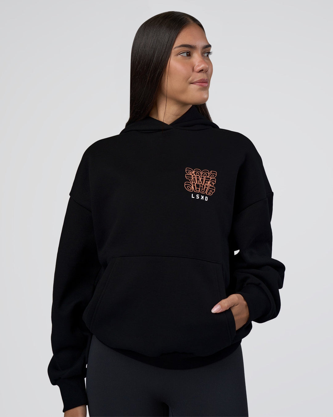 Woman wearing GTC CVC Fleece Unisex Oversized Hoodie - Black-Cantaloupe | Model:Rhiley | Size:XS