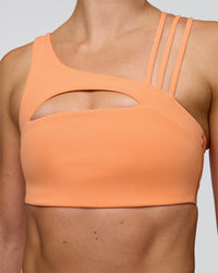 Woman wearing Galvanise Splice Sports Bra - Cantaloupe | Model:Emelia | Size:XS