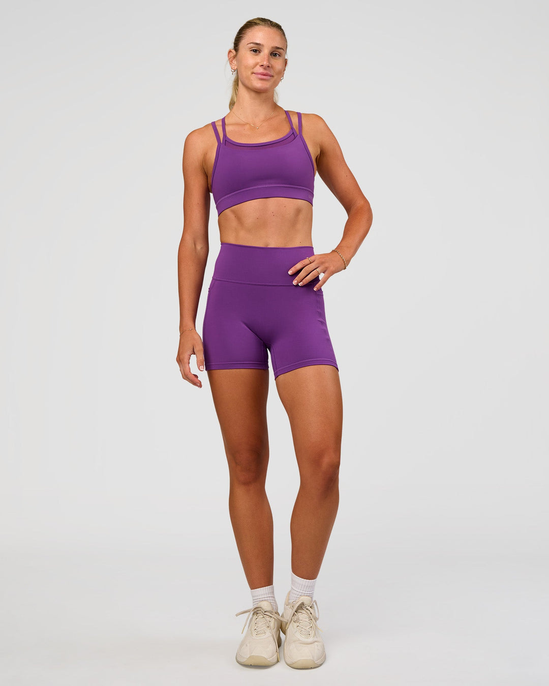 Woman wearing Genesis Layered Sports Bra - Fresh Purple | Model:Emelia | Size:XS