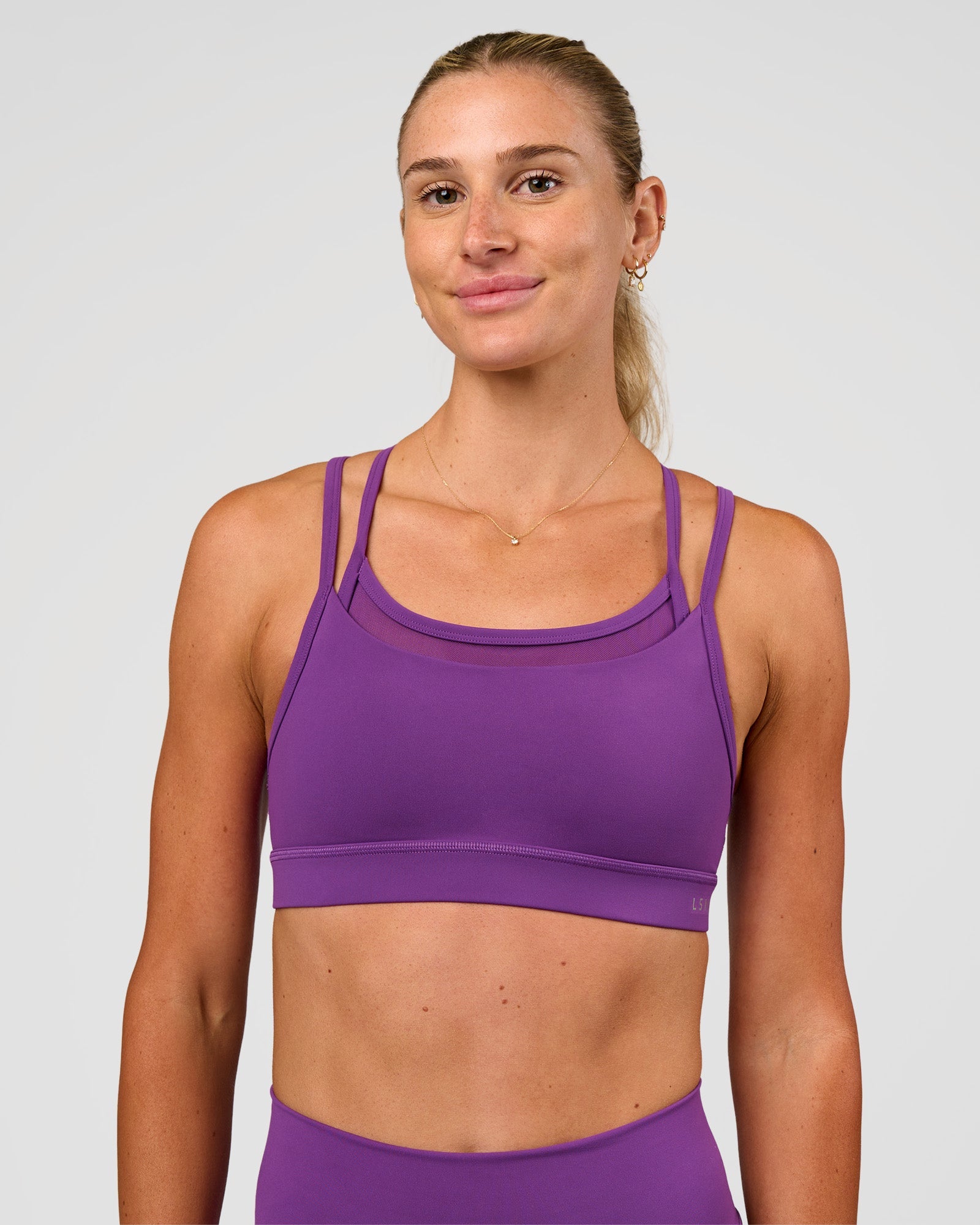 Woman wearing Genesis Layered Sports Bra - Fresh Purple | Model:Emelia | Size:XS