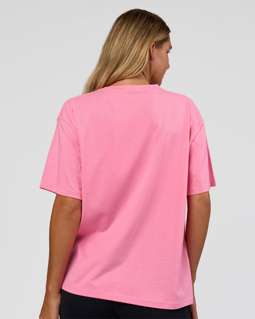 Woman wearing Go-To 1% Better Every Day FLXCotton Oversized Tee - Candy Pink-Black | Model:Amity | Size:XS
