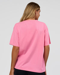 Woman wearing Go-To 1% Better Every Day FLXCotton Oversized Tee - Candy Pink-Black | Model:Amity | Size:XS