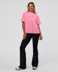 Woman wearing Go-To 1% Better Every Day FLXCotton Oversized Tee - Candy Pink-Black | Model:Amity | Size:XS