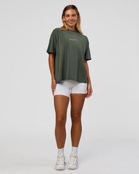 Woman wearing Go-To 1% Better Every Day FLXCotton Oversized Tee - Carbon Green Washed-White | Model:Amity | Size:XS