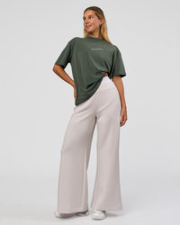 Woman wearing Go-To 1% Better Every Day FLXCotton Oversized Tee - Carbon Green Washed-White | Model:Amity | Size:XS