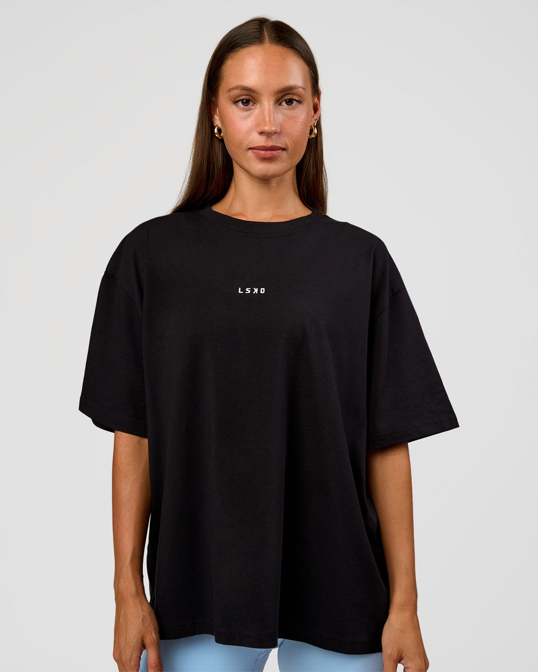 Woman wearing Go-To Break Through FLXCotton Oversized Tee - Black-Open Air | Model:Brylee | Size:XS