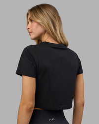 Woman wearing Go-To FLXCotton Baby Tee - Black-White | Model:Leilani | Size:XS
