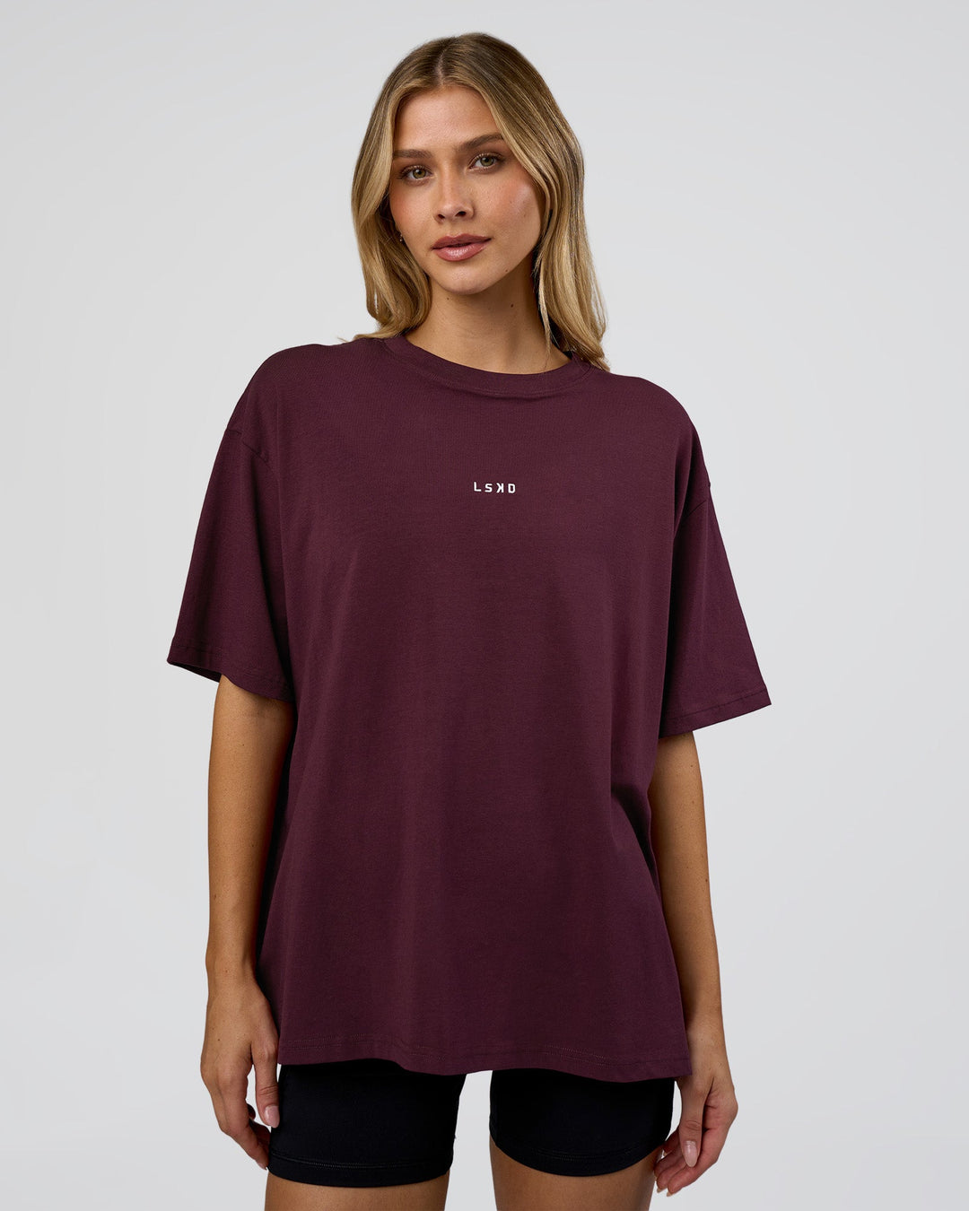Woman wearing Go-To FLXCotton Oversized Tee - Cherry Lacquer-White | Model:Leilani | Size:XS - view 1