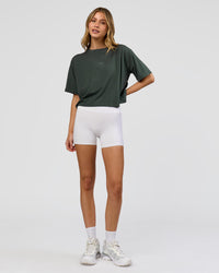 Woman wearing Go-To FLXCotton Skimmer Tee - Carbon Green-Carbon Green | Model:Leilani | Size:XS