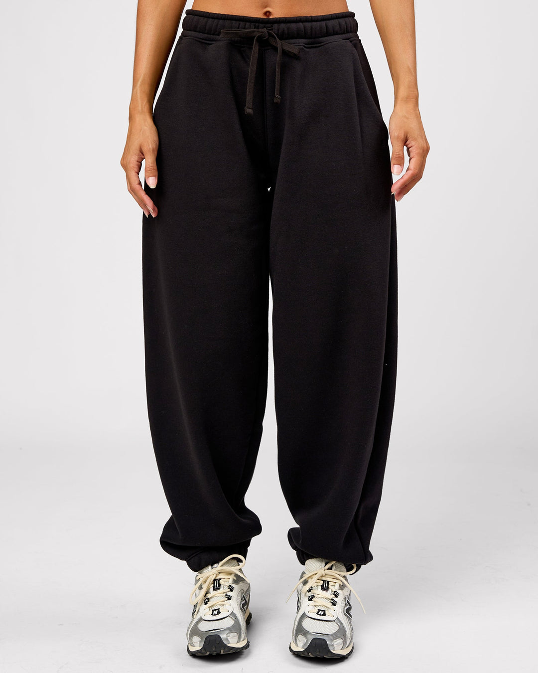 Woman wearing Go-To Oversized Track Pant - Black | Model:Brylee | Size:XS - view 1