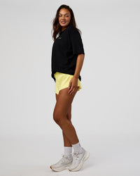 Woman wearing High Run FLXCotton Oversized Tee - Black-Yellow Fizz | Model:Kirstyn | Size:XS