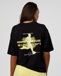 Woman wearing High Run FLXCotton Oversized Tee - Black-Yellow Fizz | Model:Kirstyn | Size:XS