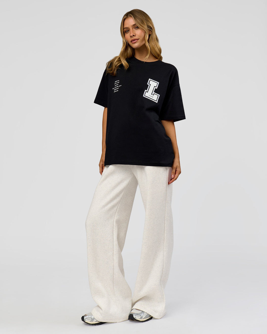Woman wearing Hype Heavyweight Unisex Oversized Tee - Black-White | Model:Leilani | Size:XS