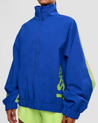 Woman wearing Hype Oversized Track Jacket - Electric Indigo | Model:Brylee | Size:XS