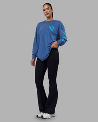 Woman wearing Inferno Journey FLXCotton Oversized Long Sleeve Tee - Midnight Blue-Blue Bird | Model:Rhiley | Size:XS