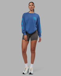 Woman wearing Inferno Journey FLXCotton Oversized Long Sleeve Tee - Midnight Blue-Blue Bird | Model:Rhiley | Size:XS