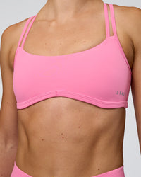 Woman wearing Interstellar Sports Bra - Candy Pink | Model:Emelia | Size:XS