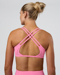Woman wearing Interstellar Sports Bra - Candy Pink | Model:Emelia | Size:XS