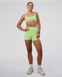 Woman wearing Interstellar Sports Bra - Solar Lime | Model:Emelia | Size:XS