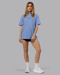 Woman wearing Just Run FLXCotton Oversized Tee - Soft Blue-Dark Storm | Model:Emilie | Size:XS