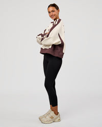 Woman wearing LSKD Fitness Club Oversized Sweater - Off White-Cocoa Powder | Model:Brylee | Size:XS