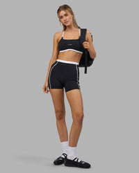 Woman wearing Liberate Contrast High-Rise 4" Short Pockets - Black-White | Model:Leilani | Size:XS