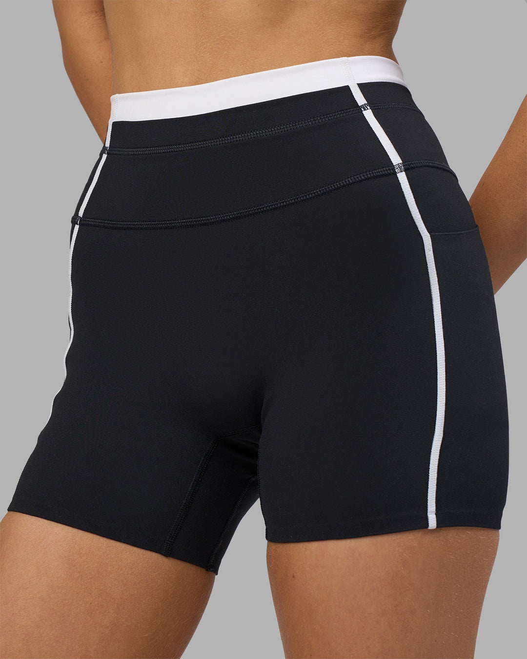 Woman wearing Liberate Contrast High-Rise 4" Short Pockets - Black-White | Model:Leilani | Size:XS