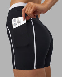 Woman wearing Liberate Contrast High-Rise 4" Short Pockets - Black-White | Model:Leilani | Size:XS