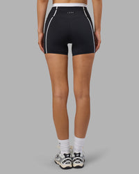 Woman wearing Liberate Contrast High-Rise 4" Short Pockets - Black-White | Model:Leilani | Size:XS