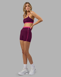 Woman wearing Liberate Contrast High-Rise 4" Short Pockets - Plum Caspia-Ultra Pink | Model:Leilani | Size:XS