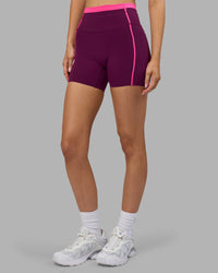 Woman wearing Liberate Contrast High-Rise 4" Short Pockets - Plum Caspia-Ultra Pink | Model:Leilani | Size:XS