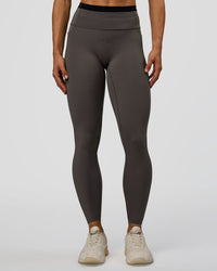 Woman wearing Liberate High-Rise Full Length Legging Pockets in Duskstone-Black | Model:Maja | Size:XS