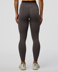 Woman wearing Liberate High-Rise Full Length Legging Pockets in Duskstone-Black | Model:Maja | Size:XS